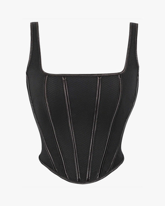 Haut corset noir sur fond studio gris clair