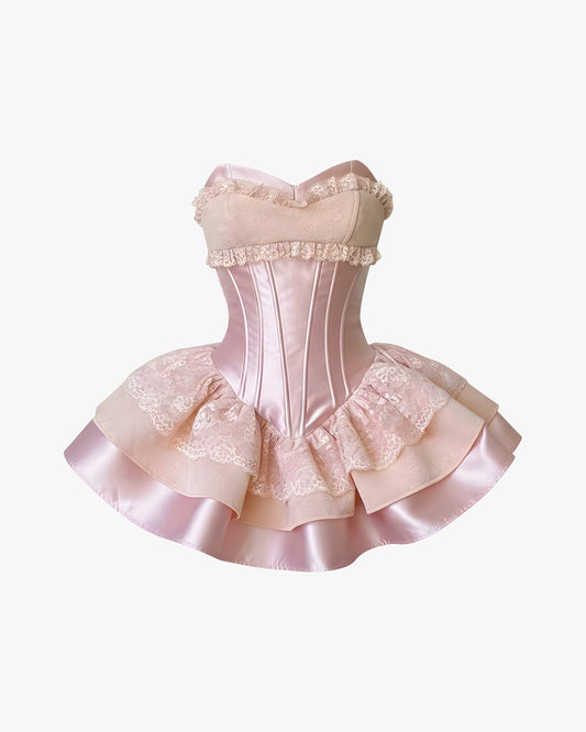 Robe corset rose sur fond studio gris clair