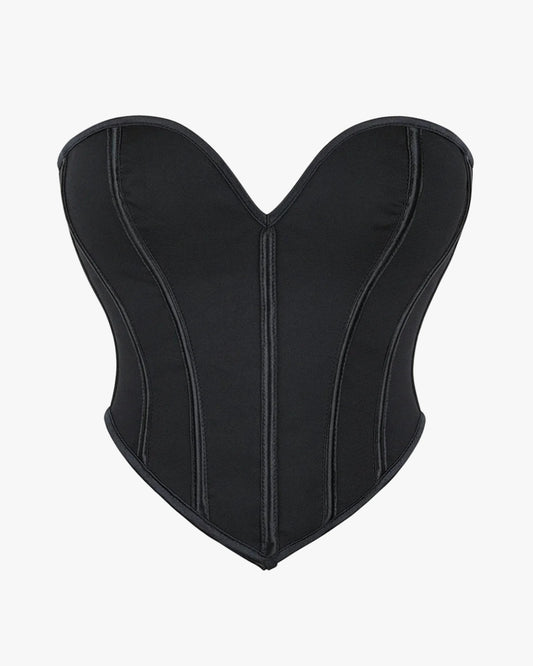 Top corset noir sur fond studio gris clair